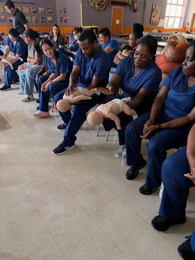 Group practicing CPR compressions on training mannequins